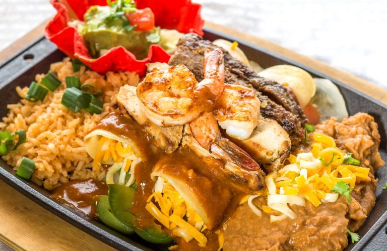 Enchilada dinner plate with refried beans and rice